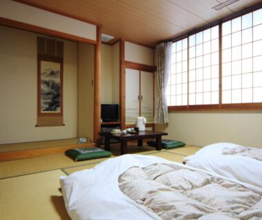 Tatami room with futons, low table and shoji screens at Komao in Nagano, Chūbu