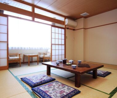 Traditional tatami room with low table, zabuton cushions and shoji screens at Komao in Nagano, Chūbu