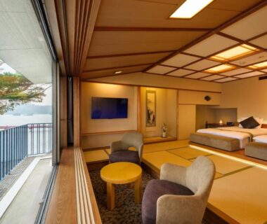 Tatami room with beds and balcony overlooking coastline at Komatsu-kan Kofu-tei in Miyagi, Tōhoku