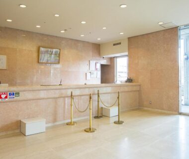 Marble reception desk with low benches at Komoro Grand Castle Hotel lobby, Nagano, Chūbu, Japan