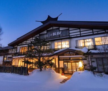 Traditional snow-covered ryokan entrance at dusk, Konashi No Yu Sasaya, Nagano, Chūbu region