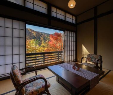 Traditional tatami room with low table, shoji screens and colorful foliage view at Konashi No Yu Sasaya in Nagano