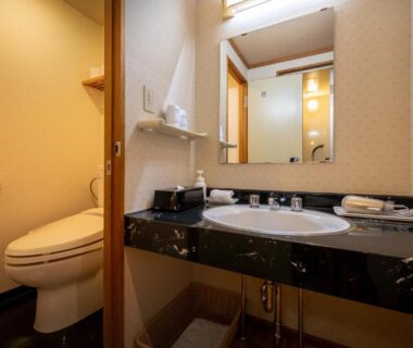 Marble sink and mirrored vanity with toilet stall at Konjakutei, Fukushima, Tōhoku, Japan