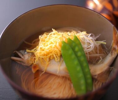 Bowl of clear broth with fish, shredded egg, snow pea and thin noodles at Koorogirou in Ishikawa