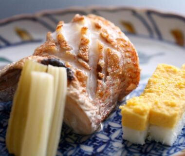 Grilled fish and tamagoyaki on ceramic plate at Koorogirou ryokan in Chubu Ishikawa