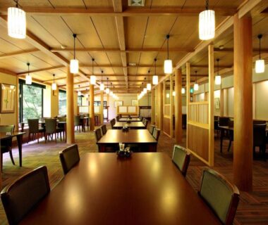 Spacious wooden dining hall with tables and chairs at Kose Onsen in Nagano Chūbu Japan