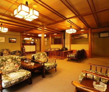 Cozy lounge with wooden beams and upholstered chairs at Kose Onsen, Nagano, Chūbu, Japan