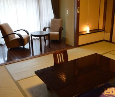 Tatami room with low lacquered table and seating area at Kotobukitei, Mie, Kansai