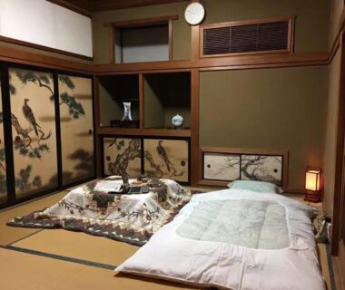 Traditional tatami room with futons, low kotatsu table and painted fusuma screens at Kougetsu Sanso Tokyo