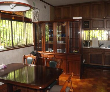 Sunlit wooden dining area with table, chairs and cabinetry at Kougetsu Sanso Moon Villa in Tokyo