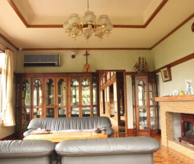 Sofa seating and fireplace in communal lounge at Kougetsu Sanso, Tokyo, Kanto