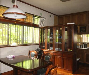 Wooden dining area with table and glass cabinet at Kougetsu Sanso Moon Villa in Tokyo, Kantō, Japan