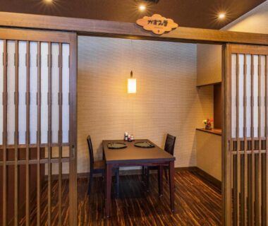 Dining alcove with wooden table, chairs and shoji sliding doors at Kouunsou in Tochigi
