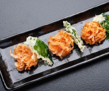 Crispy fried morsels with green leaf garnish on black plate, Kouyurou Ikawa, Chūbu Shizuoka Japan