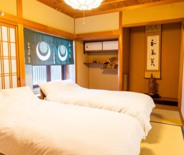 Tatami room with two beds, shoji screens and tokonoma alcove at Koyasan Gokuraku Stay in Wakayama