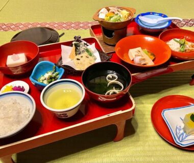 Lacquer trays with rice, soup, assorted small dishes and tea served on tatami at Koyasan Sanadabo Rengejoin, Wakayama