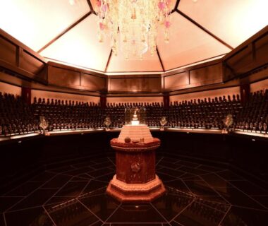 Circular ceremonial chamber with chandelier and rows of small statues at Koyasan Shukubo Fugenin, Wakayama