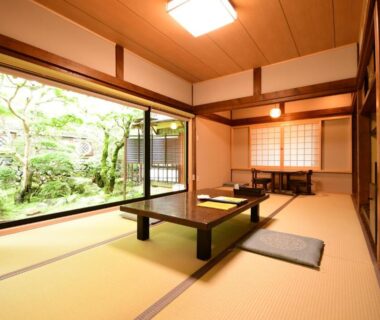 Traditional tatami room with low table, shoji screens and garden view at Koyasan Shukubo Jokiin, Wakayama