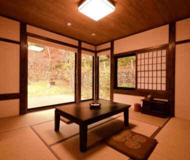 Traditional tatami room with low table, shoji screens and garden view at Koyasan Shukubo Jokiin, Wakayama