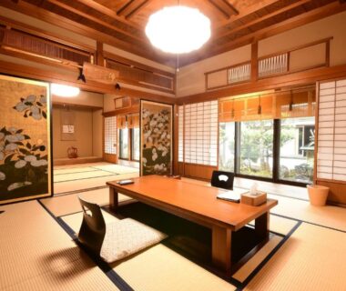 Spacious tatami room with low table, shoji screens and garden view at Koyasan Shukubo Yochiin Wakayama