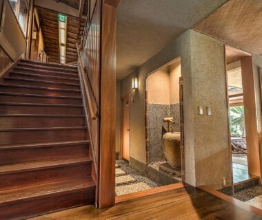Wooden staircase and stone basin in corridor at K's House Ito Onsen Historical Ryokan Hostel, Shizuoka, Chubu, Japan
