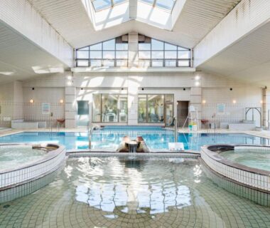 Bright indoor communal baths with skylight at Kurhouse Shirahama in Wakayama Japan