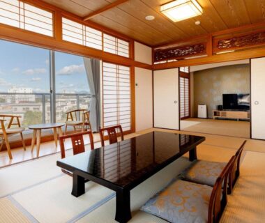 Tatami room with low table, shoji screens and balcony seating at Kurhouse Shirahama, Wakayama