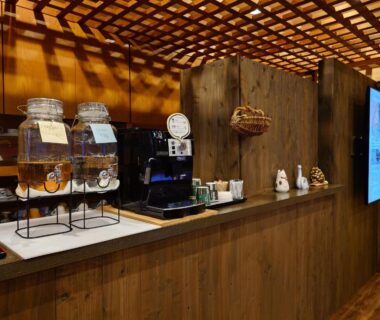 Coffee machine and drink dispensers on a wooden counter at Kurokawa Onsen Ryokan Ichinoi in Kumamoto