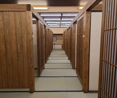 Corridor with tatami flooring, wooden partitioned rooms and shoji screens at Kurokawa Onsen Ryokan Ichinoi, Kumamoto
