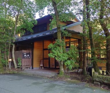 Wooden entrance of Kurokawa Onsen Ryokan Ichinoi surrounded by forest in Kumamoto, Kyushu