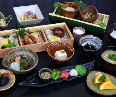 Tray of small Japanese dishes with rice, miso, sashimi and fruit at Kurokawa Onsen Yama no Yado Shinmeikan, Kumamoto
