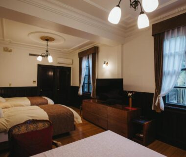 Wooden guest room with multiple beds at Kurokawa-So in Kumamoto, Kyushu