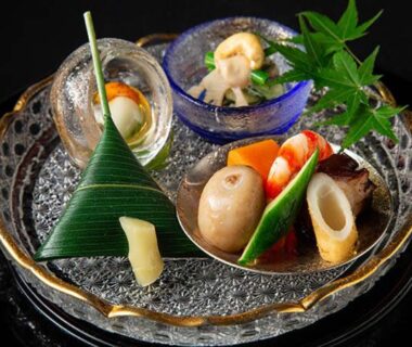 Assorted bite-sized Japanese appetizers on glass plate at Kurokawa-So, Kumamoto, Kyūshū, Japan