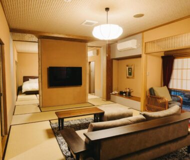 Tatami room with sofa, low table and futon at Kurokawa-So in Kumamoto, Kyūshū