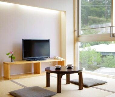 Tatami seating with low table and cushions at Kusatsu Hotel Bekkan in Gunma