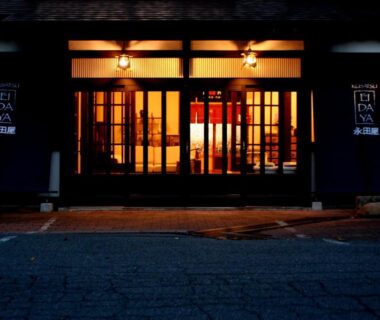Illuminated wooden-framed entrance with warm lighting at Kusatsu Onsen Eidaya, Gunma, Kantō, Japan