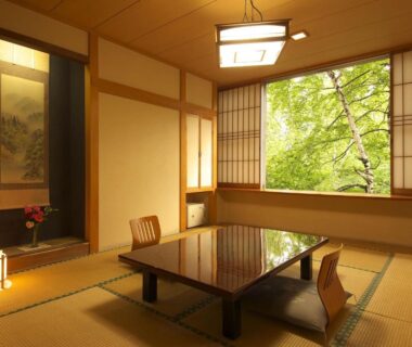 Traditional tatami room with low table and shoji screens at Kusatsu Skyland Hotel, Gunma