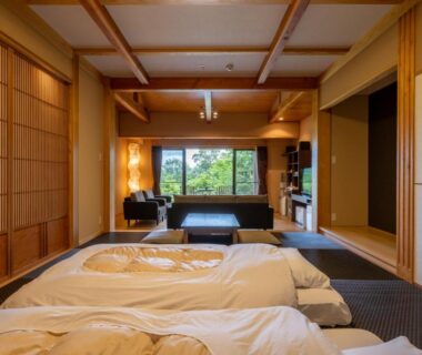 Tatami room with futon bedding and garden view at Kusayane no yado Ryunohige in Ōita, Kyūshū