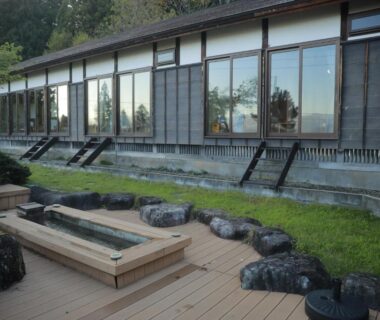 Wooden outdoor soaking basin on deck with stone accents outside Kutsurogian in Niigata, Chūbu, Japan