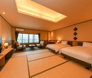 Spacious tatami room with twin beds and seating area at Kutsurogijuku Chiyotaki, Fukushima