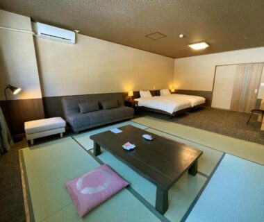 Tatami seating with low table, sofa and twin beds at Kutsurogijyuku Shintaki, Fukushima