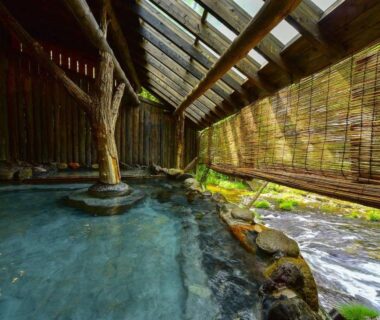 Covered riverside onsen bath with bamboo blinds and wooden pillar, Kutsurogijyuku Shintaki, Fukushima