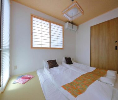 Tatami room with futons and shoji screens at Kyo Machiya Ryokan Yuan Kyoto