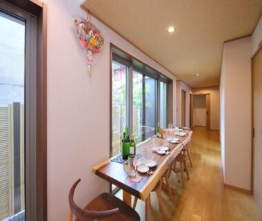 Narrow dining corridor with wooden table and place settings at Kyo Machiya Ryokan Yuan, Kyoto, Kansai