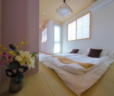 Tatami room with futon bedding and shoji windows at Kyo Machiya Ryokan Yuan in Kyoto