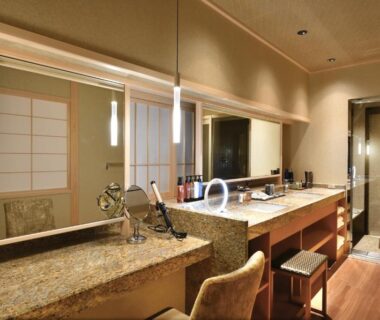 Double sink vanity with warm lighting and shoji screens at Kyo Yunohana Resort Suisen, Kyoto