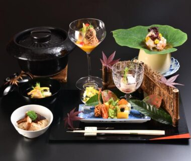 Assorted small dishes on lacquer tray with chopsticks and glass, ryokan dining at Kyo Yunohana Resort Suisen