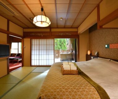Tatami-floored guest room with twin beds, shoji sliding doors and garden view at Kyo Yunohana Resort Suisen Kyoto