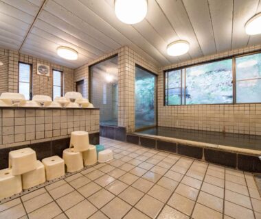 Tiled communal bathing area with stools and wash stations at Kyo no Minshuku Ohara no Sato Kyoto