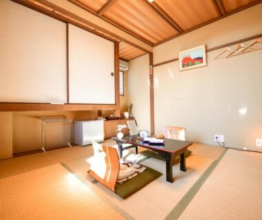 Traditional tatami room with low table, floor cushions, shoji screens and wooden ceiling at Kyo no Yado Sangen Ninenzaka Kyoto